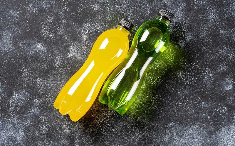 Bottles with yellow and green transparent liquid