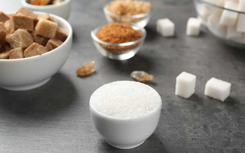 Various kinds of sugar on a gray table