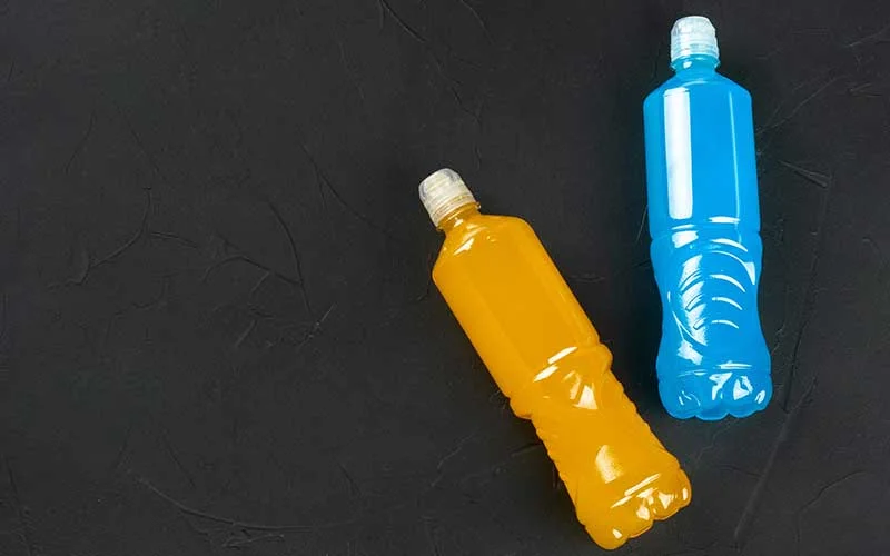 Plastic bottle with Water enhancer drinks for sports on a dark background