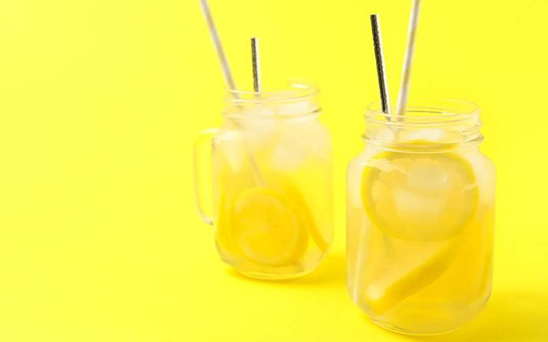Natural lemonade on yellow background