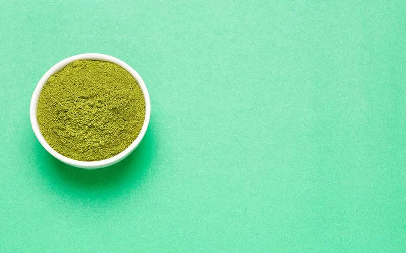 Superfood green powder on a green background