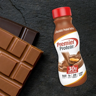 Premier Protein Shake and chocolate on dark background