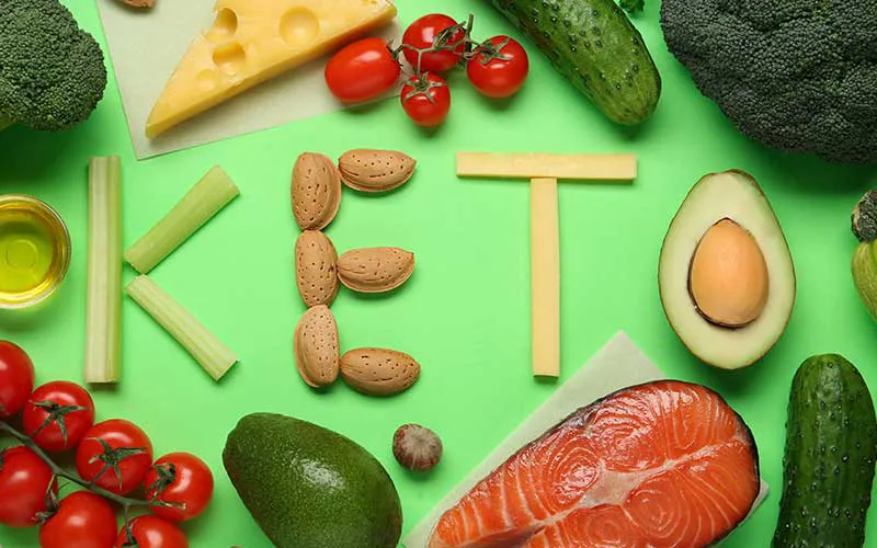 Concept of healthy eating with text keto on green background